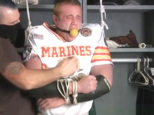 Tall redheaded football player bound gagged and stripped.